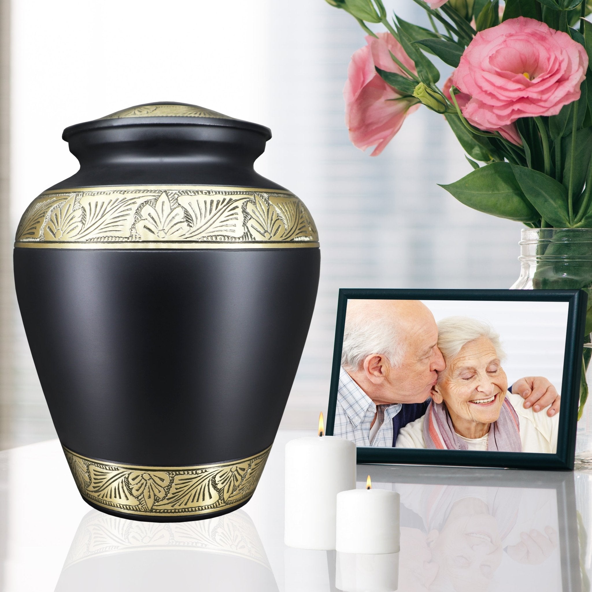 Sophisticated black intricate gold engraving metal funeral urn, heartfelt remembrance of mom and dad with pink blooms